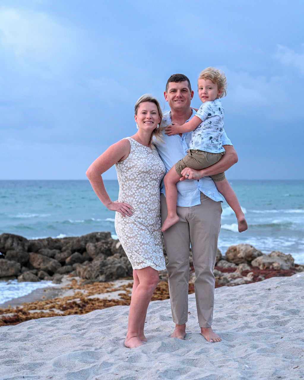 The Nicoli family walking together on a Florida beach at golden hour