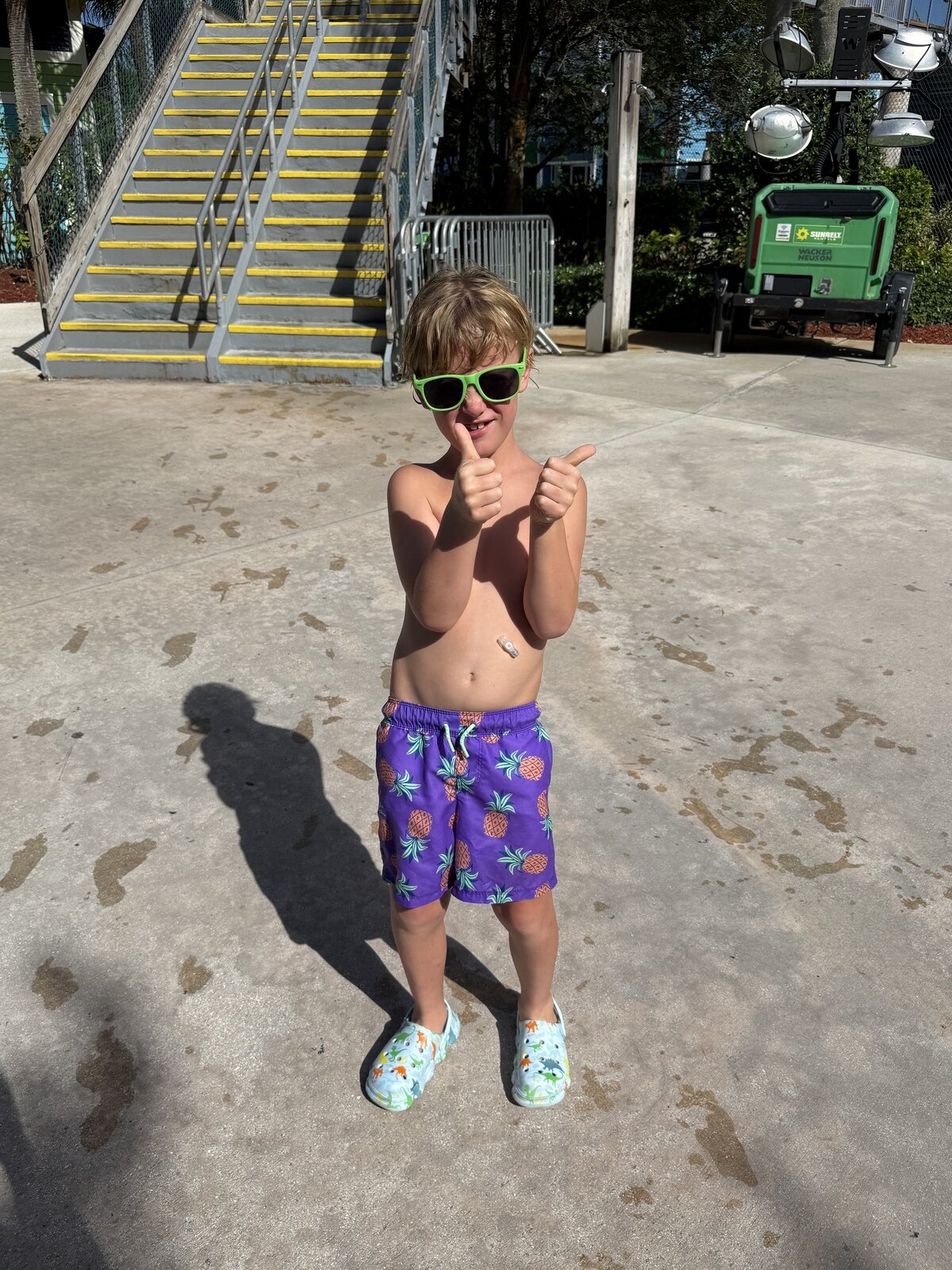 Logan giving two thumbs up in his sunglasses after a swim