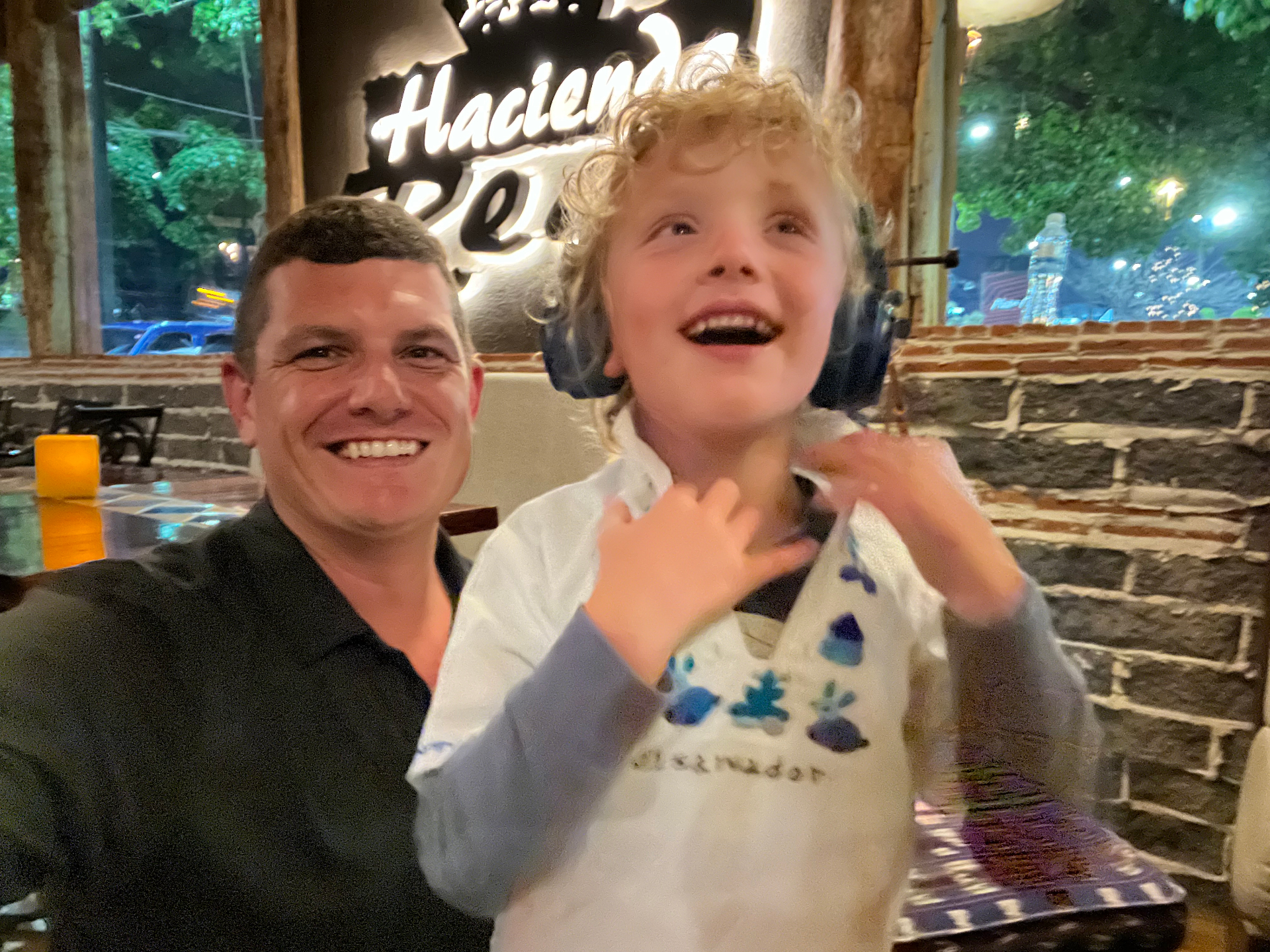 Dad and Logan laughing together at dinner