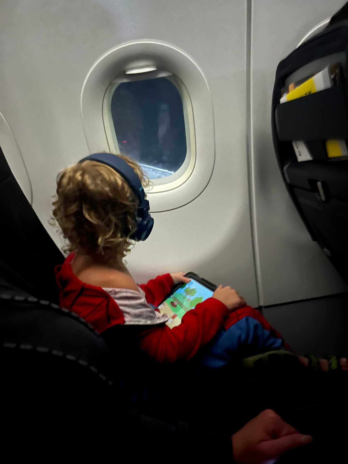 Logan on an airplane watching out the window